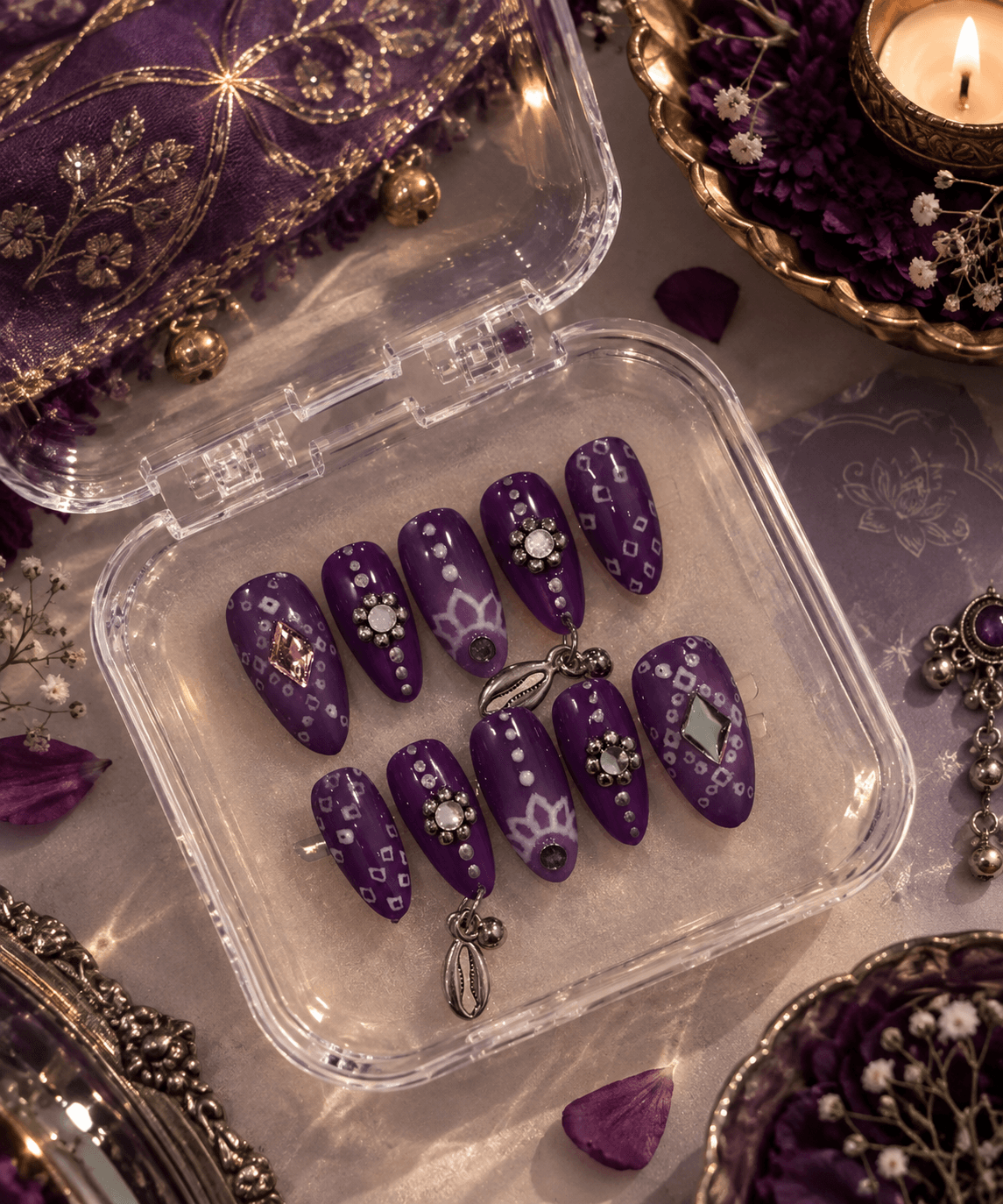 Bandhani & Jewels — Deep purple & white ombre almond nails with bandhani-style patterns, mirror gems, and dangling silver charms.