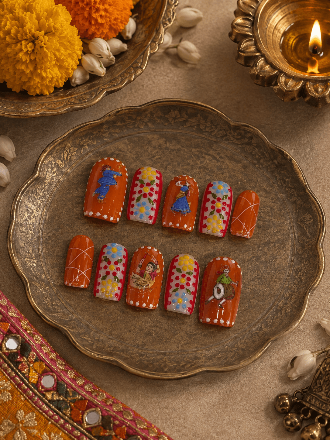 Garba Nights — Vibrant orange square nails with hand-painted garba dancers, a dhol player, and folk florals.